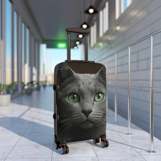 Photo-realistic green-eyed cat face carry-on suitcase by Printify, durable bag with detailed feline features and vibrant colors.