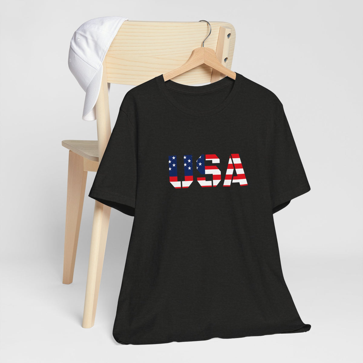 USA flag text patriotic T-shirt by Printify featuring red, white, and blue design for Fourth of July celebrations.