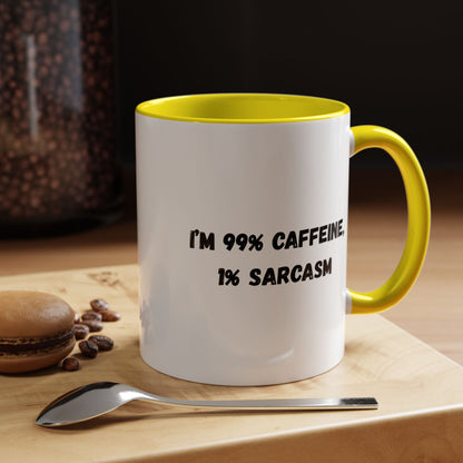 Ceramic coffee mug with "I'm 99% Caffeine, 1% Sarcasm" print, featuring a white background and colorful text design.