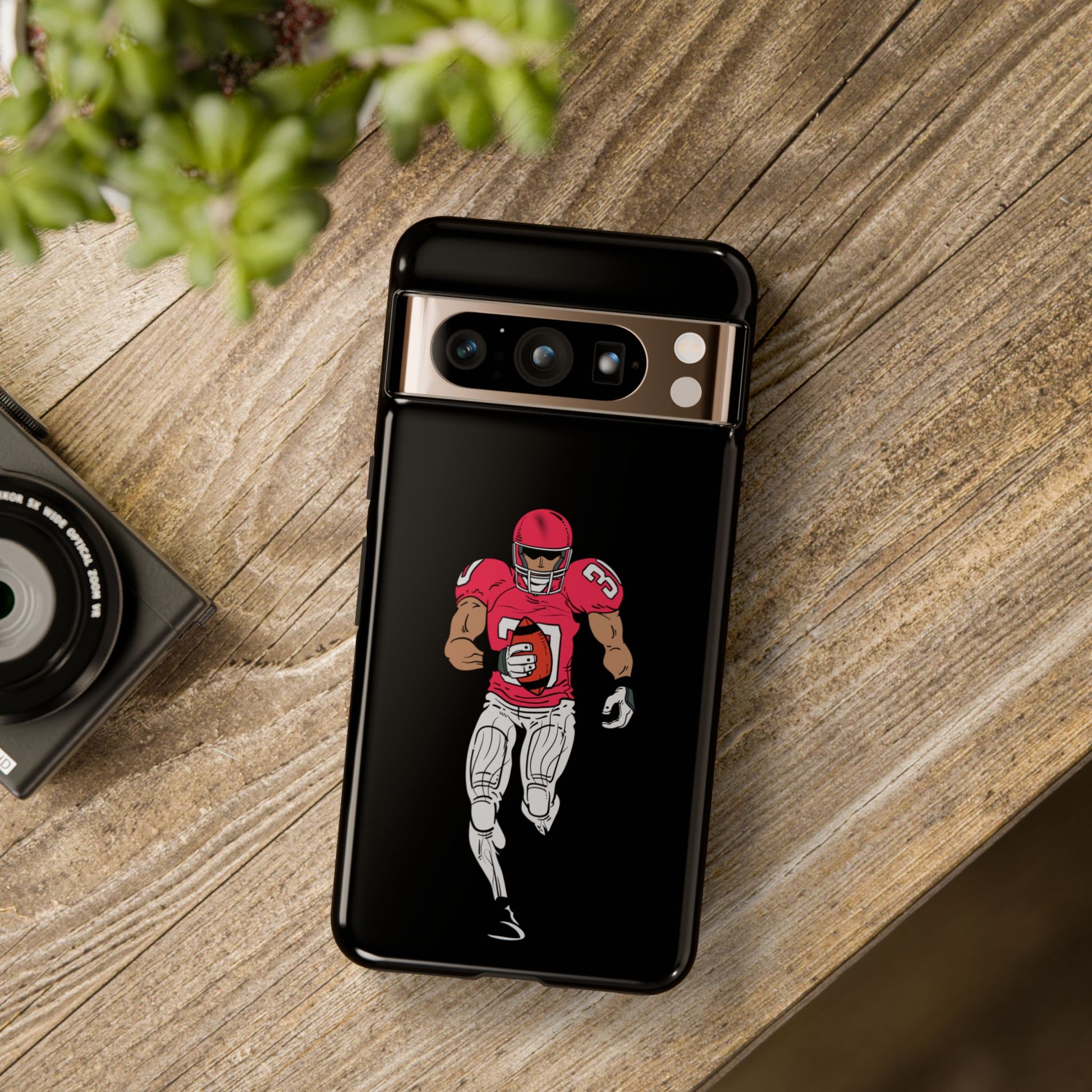 Black football player tough phone case for iPhone, protective sports design by Printify, featuring an athletic football scene.