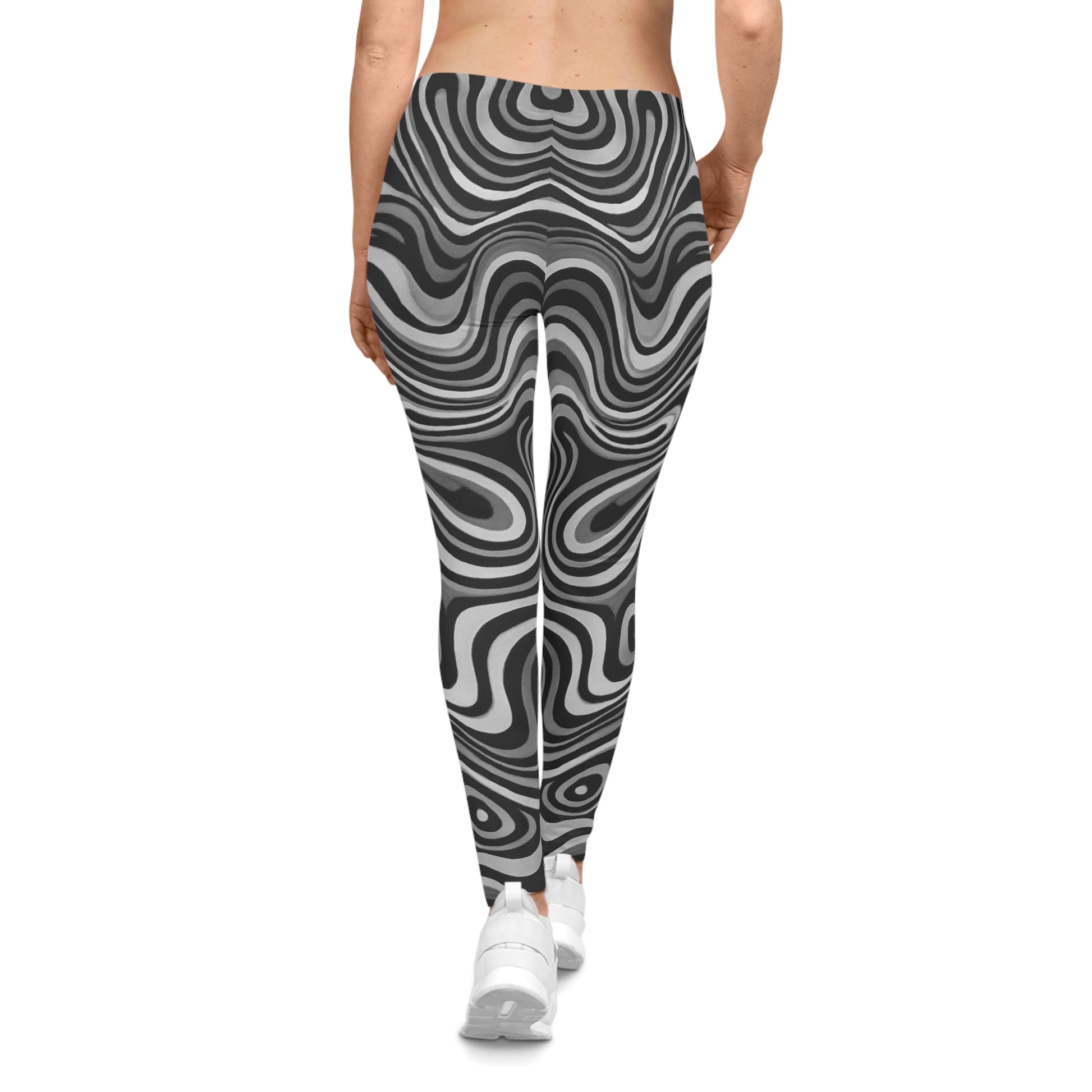 Black and white swirl all-over print leggings with retro psychedelic pattern, designed by Printify, shown on a model.