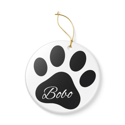 Black paw print ceramic ornament with pet's name, ideal for memorial Christmas decoration, by Printify.