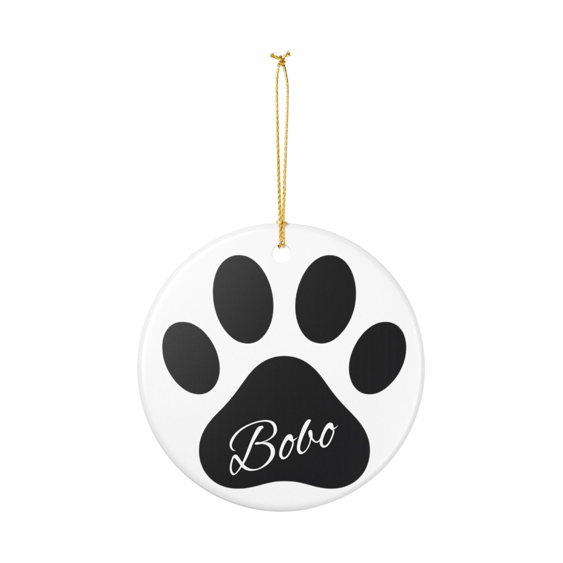 Black paw print ceramic ornament with pet's name, ideal for memorial Christmas decoration, from Printify.