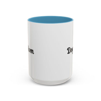 Dog Mom Accent Coffee Mug — white ceramic coffee mug with retro script "Dog Mom" print, colored interior and C-handle, 11oz/15oz, angled view on wooden table