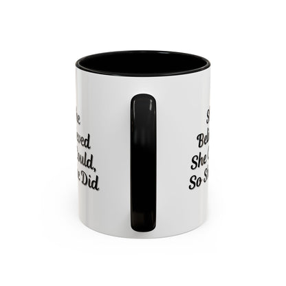 White ceramic motivational coffee mug with black text "She Believed She Could, So She Did" from Printify, front view.