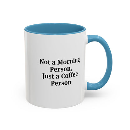 Ceramic coffee mug with "Not a Morning Person, Just a Coffee Person" print, perfect for morning beverage enjoyment.