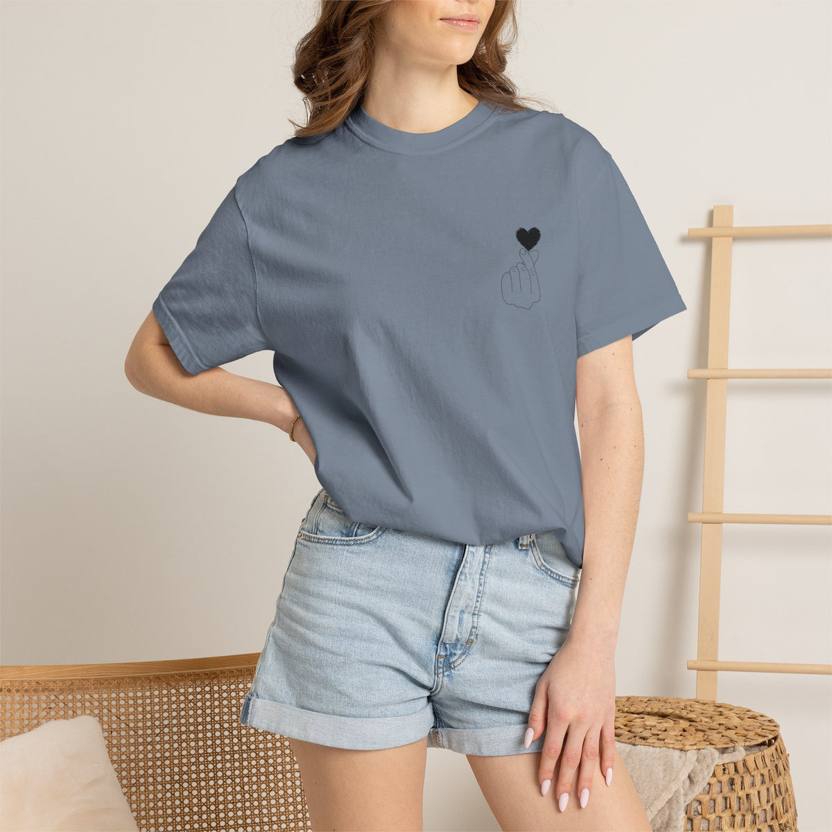 Black T-shirt with a minimal white finger heart graphic design, featuring the Printify logo on the front.