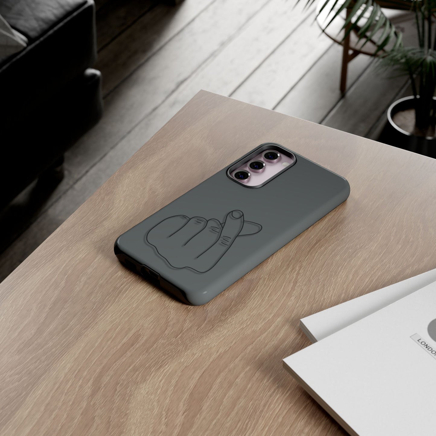 Silicone phone case with embossed Korean finger heart design, compatible with smartphones, by Printify.
