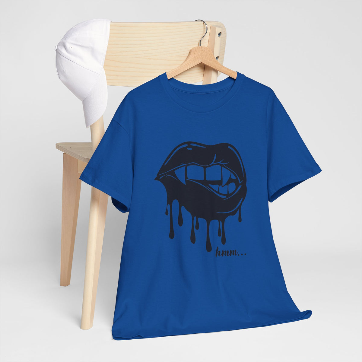 Graphic T-shirt featuring dripping lips and 'hmm...' bite design in black and white, by Printify, displayed on a model.
