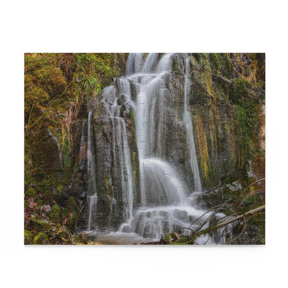 Printify Mossy Waterfall puzzle showing a scenic nature landscape with lush greenery and flowing waterfall, assembled on a flat surface.
