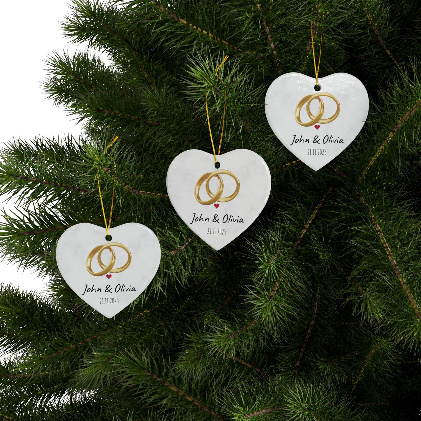 Round ceramic wedding rings ornament with personalized names and date, decorative keepsake for special occasions.
