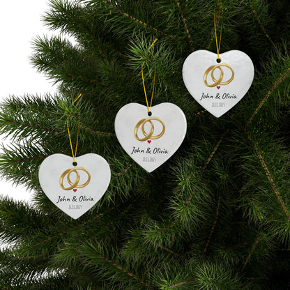 Round ceramic wedding rings ornament with personalized names and date, decorative keepsake for special occasions.