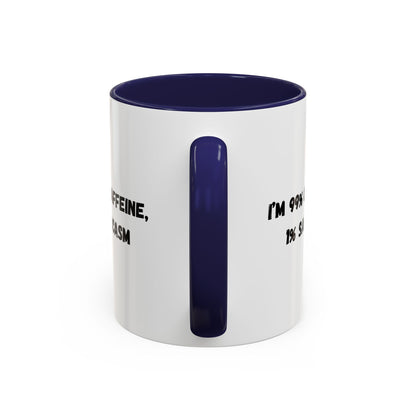Ceramic coffee mug with "I'm 99% Caffeine, 1% Sarcasm" print, featuring a white background and colorful text design.