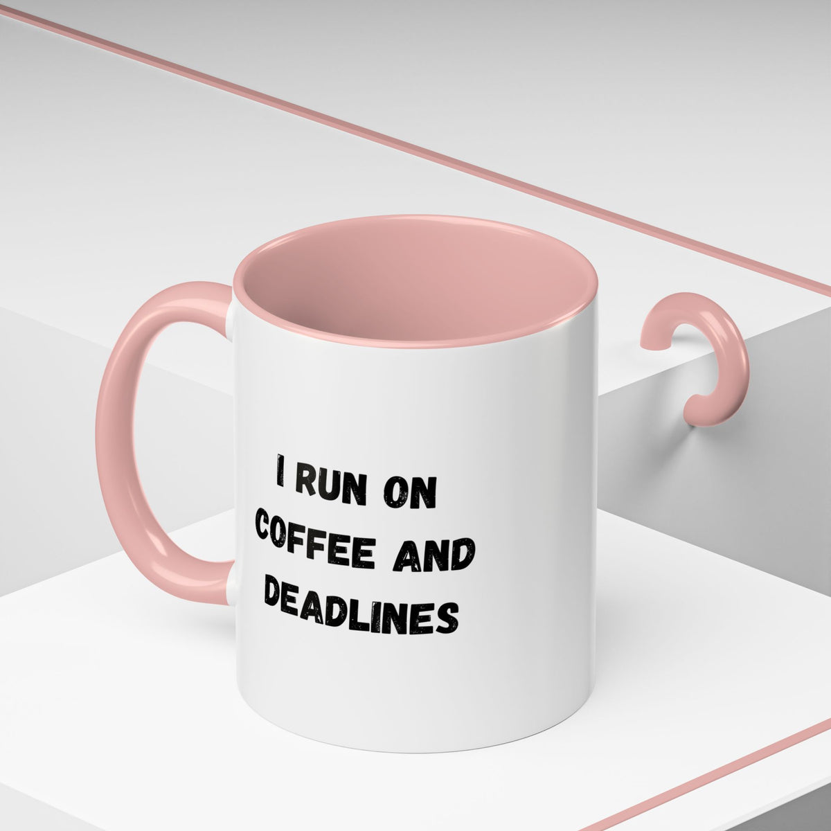 White ceramic coffee mug with "I Run on Coffee and Deadlines" text, featuring a black handle and printed design.