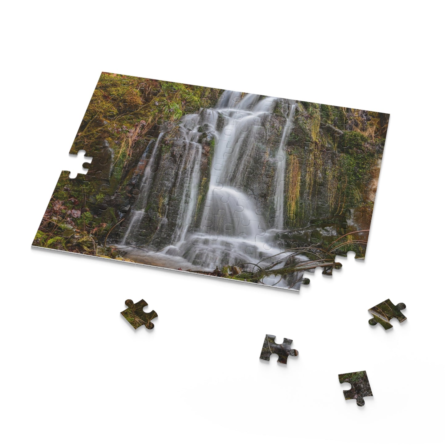 Mossy Waterfall Puzzle by Printify featuring a detailed image of a lush waterfall scene with moss-covered rocks and flowing water.