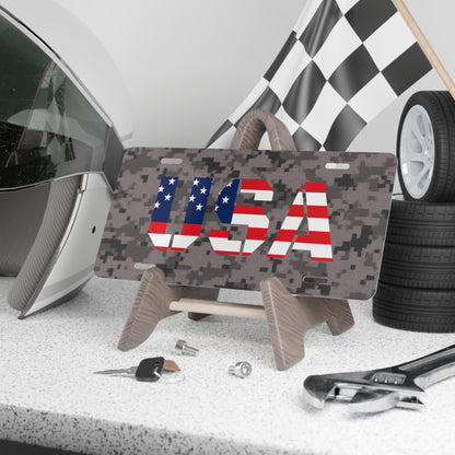 Military camo USA license plate featuring an American flag design, ideal as a patriotic accessories display.