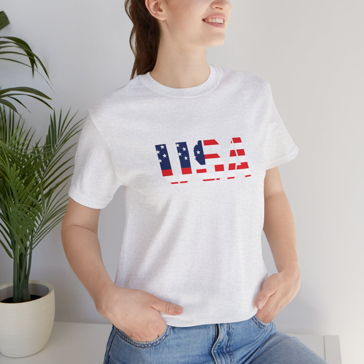 Red, white, and blue USA flag text T-shirt by Printify, featuring patriotic Fourth of July design on a casual T-shirt.