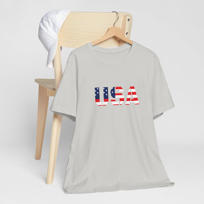 USA flag text T-shirt by Printify featuring patriotic red, white, and blue design perfect for Fourth of July celebrations.
