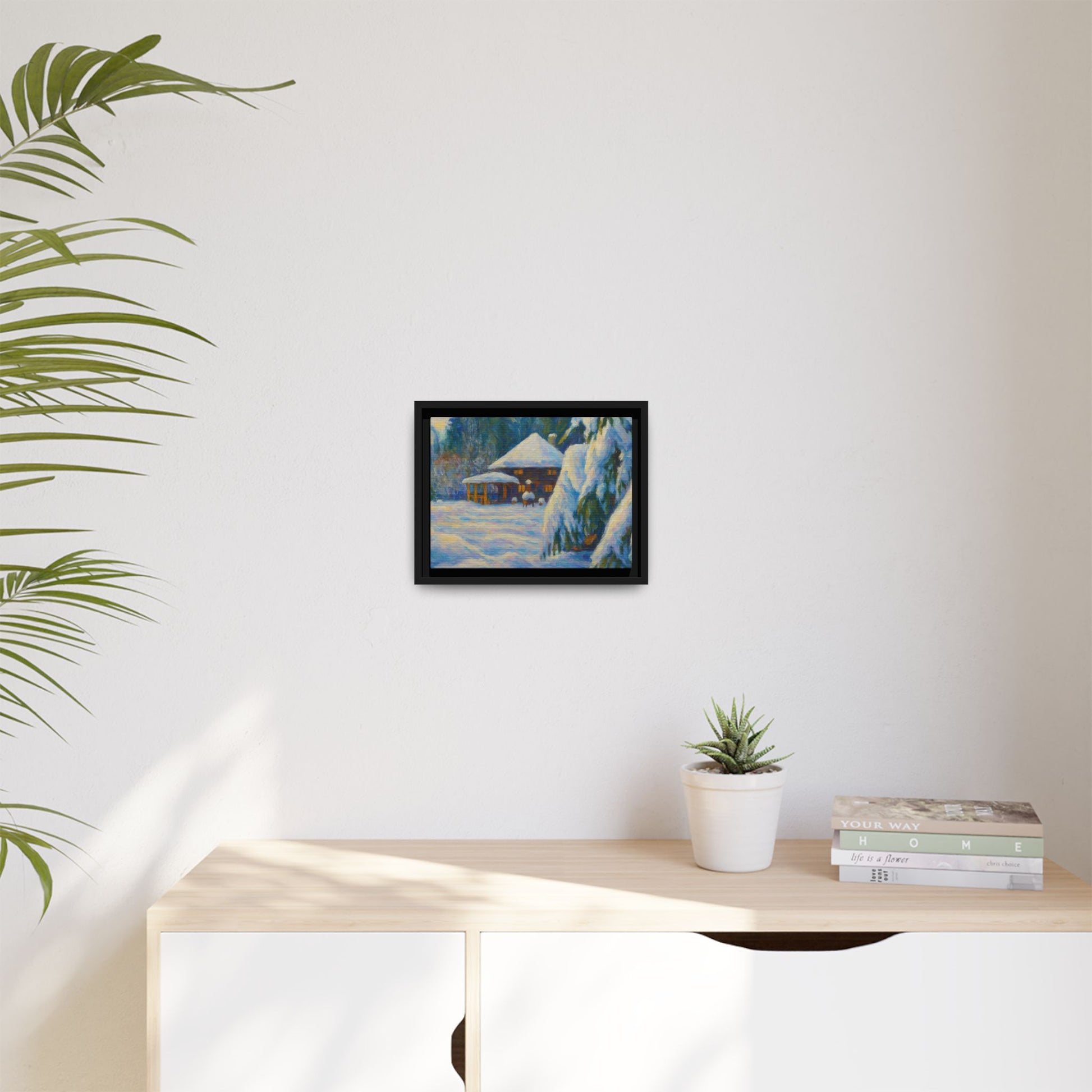Framed matte canvas wall art of a snowy cabin winter landscape by Printify, featuring a cozy cabin surrounded by snow-covered trees.
