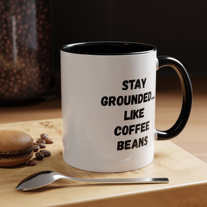 White ceramic mug with "Stay Grounded Like Coffee Beans" printed in black, 11oz size, perfect for coffee lovers.