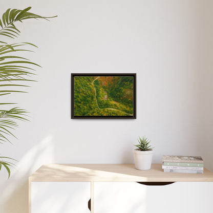 Colorful framed matte canvas wall art featuring an aerial view of a forest path landscape by Printify.