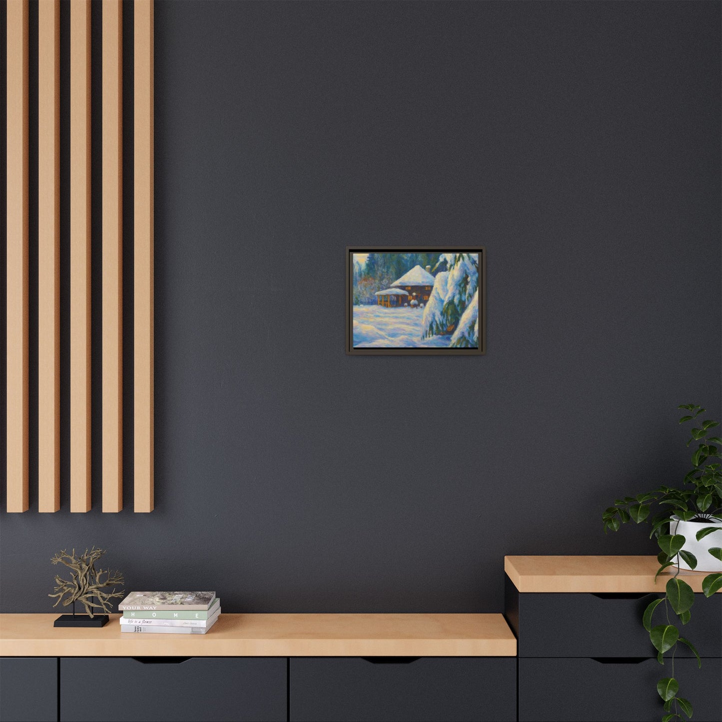 Framed matte canvas of a snowy cabin winter landscape wall art by Printify, showcasing a cozy cabin amidst snow-covered trees.