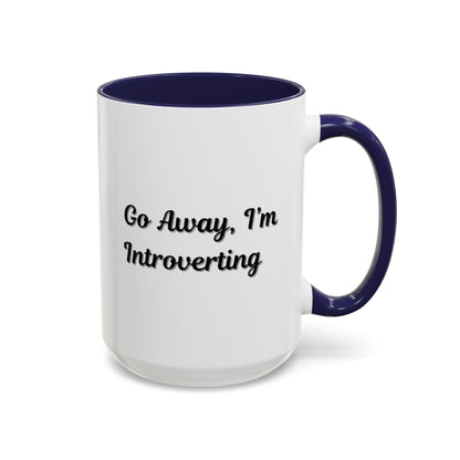 Ceramic coffee mug with "Go Away, I'm Introverting" phrase, 11 oz, white with black text, by Printify.