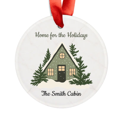 Acrylic "Home for the Holidays" cabin ornament with festive holiday design, perfect for decorating your Christmas tree.