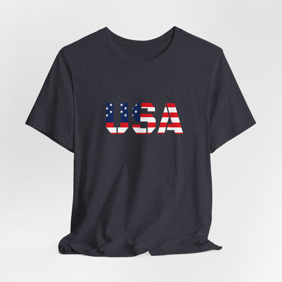 USA flag text T-shirt from Printify featuring patriotic Fourth of July design, showcasing blue, red, and white colors with bold lettering.
