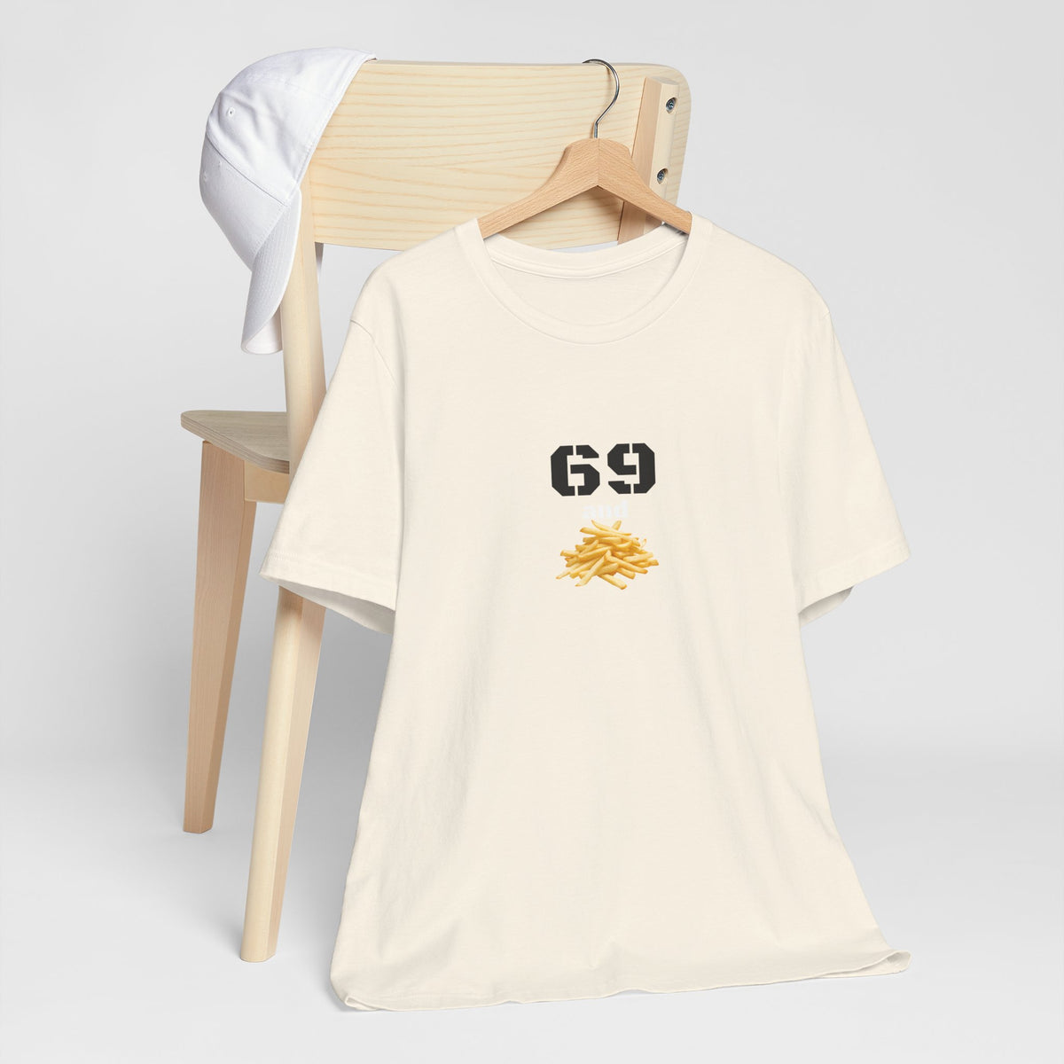 Unisex graphic T-shirt featuring humorous 69 and French fries design, casual fit, printed by Printify, on a plain background.