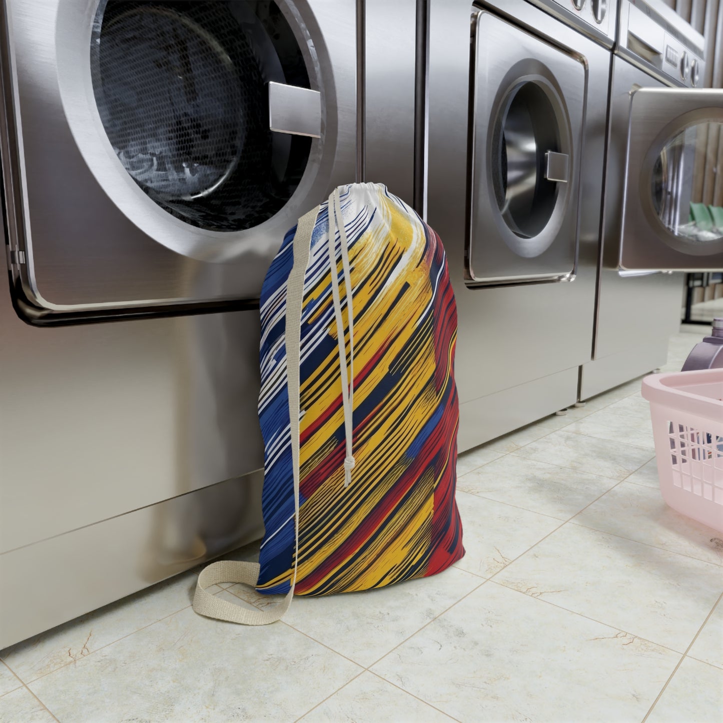 Colorful abstract brushstroke laundry bag with red, yellow, and blue design, ideal for dorms and travel by Printify.