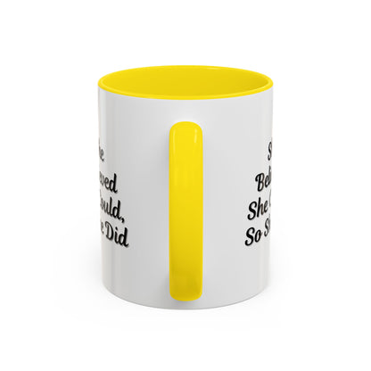 Motivational coffee mug with the phrase "She Believed She Could, So She Did" in black text on a white ceramic mug.