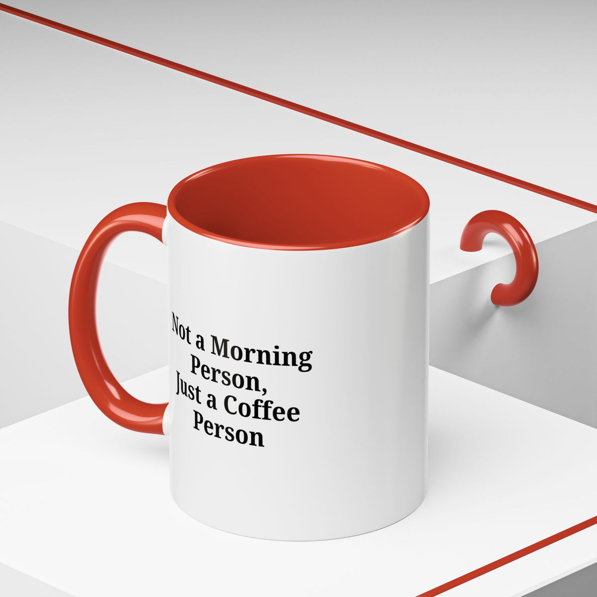 Ceramic coffee mug with the phrase "Not a Morning Person, Just a Coffee Person" in black text, featuring a white background and handle.