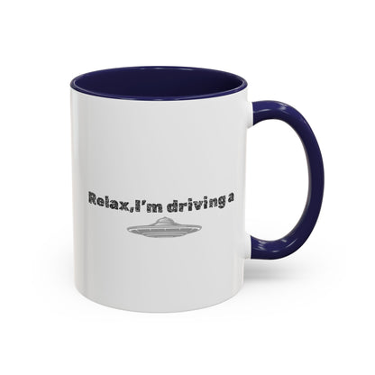 Ceramic coffee mug with "Relax, I’m Driving" UFO accent design, 11 oz, by Printify, featuring colorful extraterrestrial artwork.