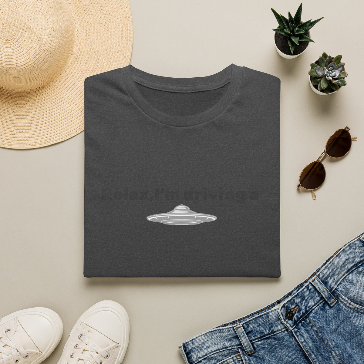 Funny alien graphic T-shirt featuring a UFO design, perfect sci-fi gift, made by Printify, shown on a casual model.