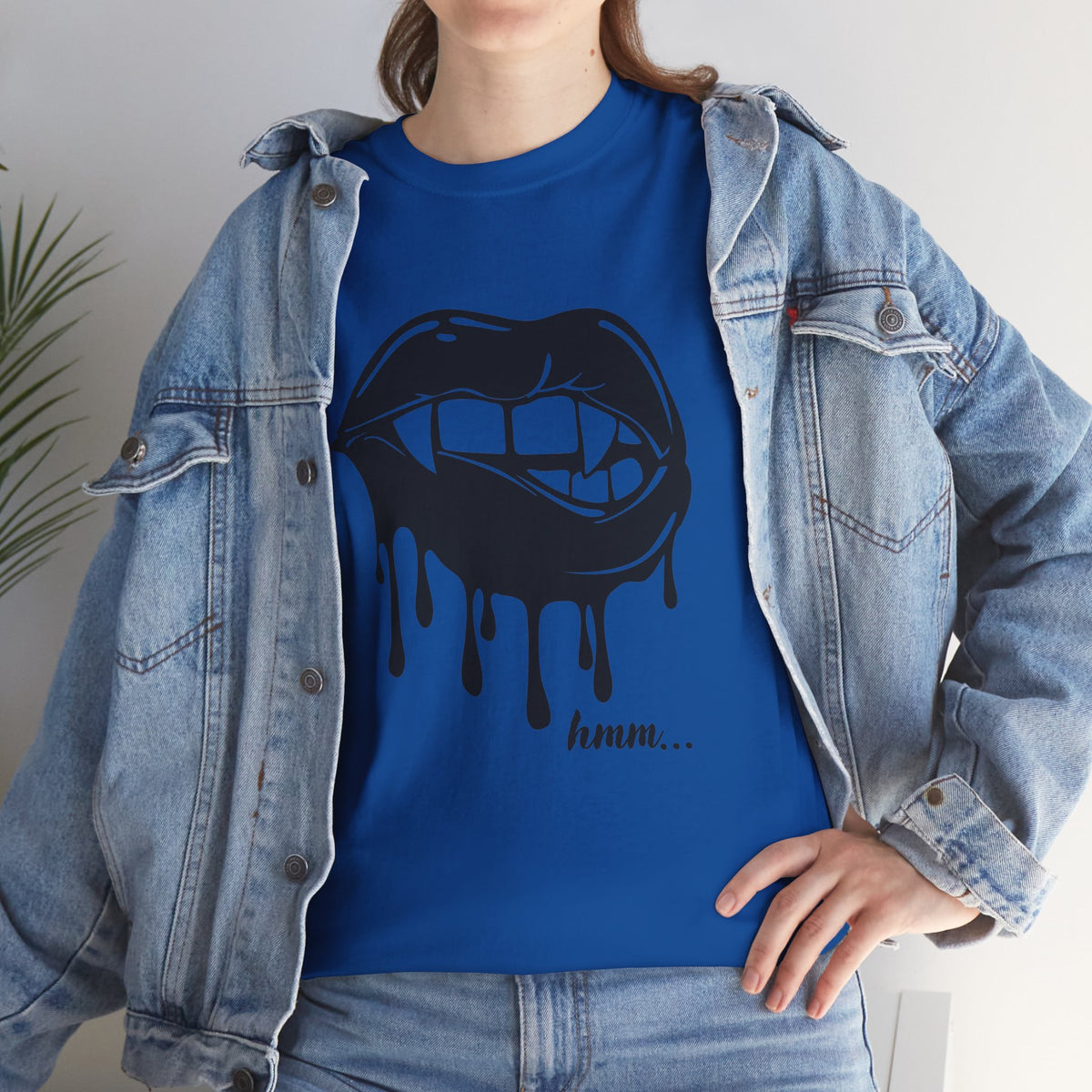 Black graphic T-shirt featuring dripping lips with a 'hmm...' bite design, by Printify, displayed on a plain background.