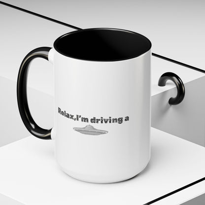 Ceramic coffee mug with "Relax, I’m Driving" UFO accent design, 11 oz, featuring a colorful extraterrestrial motif.