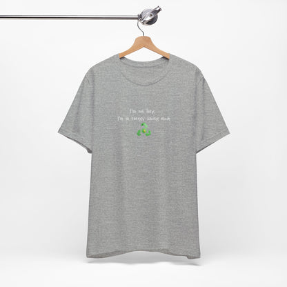 Eco humor T-shirt featuring the phrase "I’m Not Lazy, I’m an Energy-Saving Mock" on a casual Printify T-shirt.