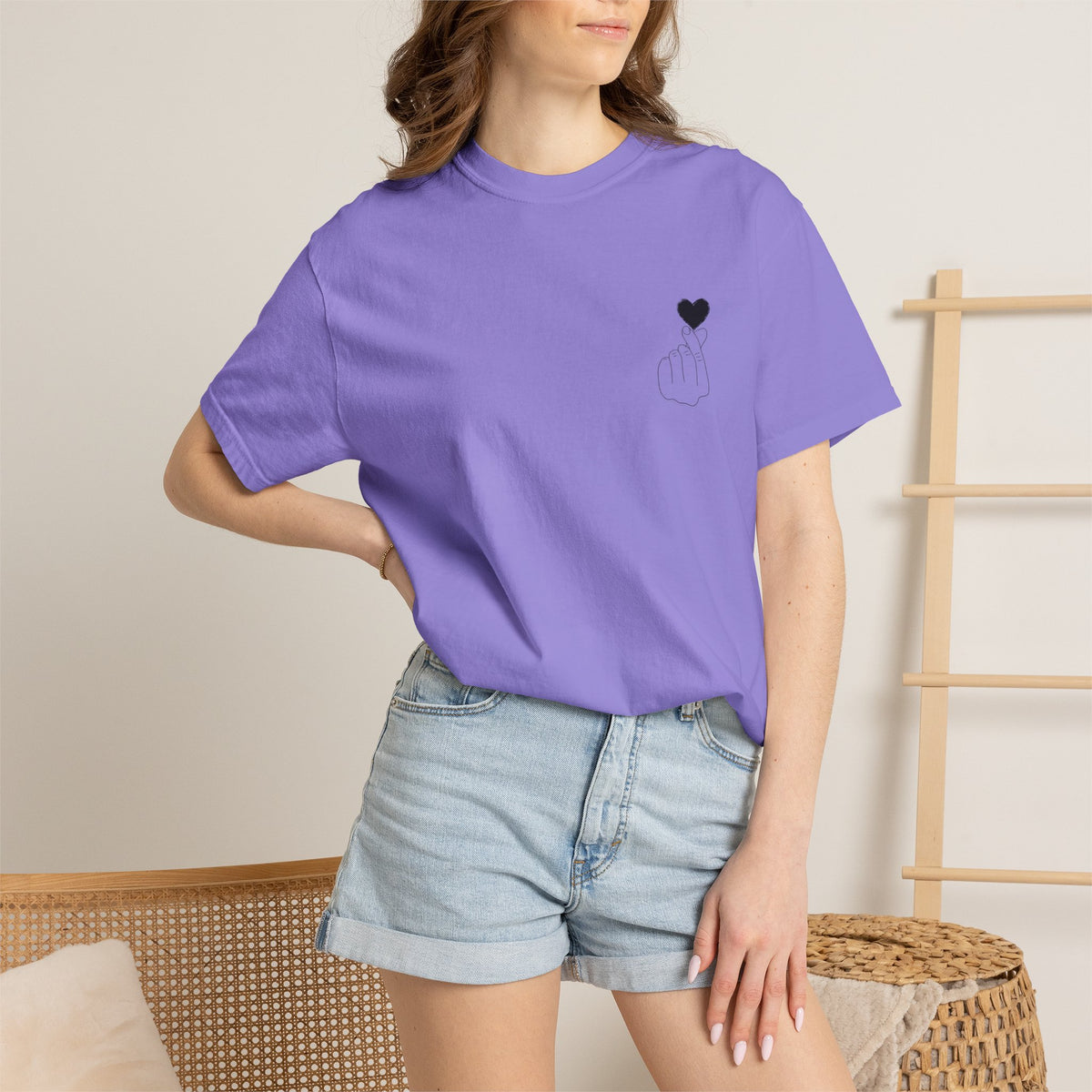 Black T-shirt with a minimal white finger heart graphic, designed by Printify, showcasing a simple and stylish graphic tee.